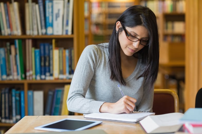 Black-haired woman studying in the library.jpeg