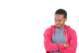 Closeup portrait of angry, mad, pissed off handsome man in pink hoodie with arms crossed looking downwards, isolated on white background with copy space.jpeg